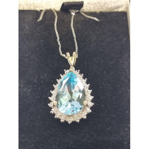 59 - A Gold, Diamond and Topaz Pendant with Chain.