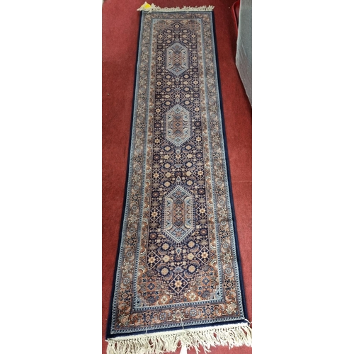 99 - A blue ground Runner with all over decoration and multi borders. 269 x 69 cms approx.