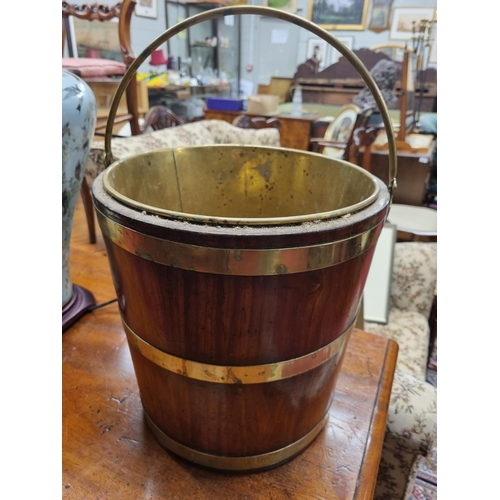 114 - A 19th Century Irish small Peat Bucket with brass liner. D 29 x H 30 cm approx.