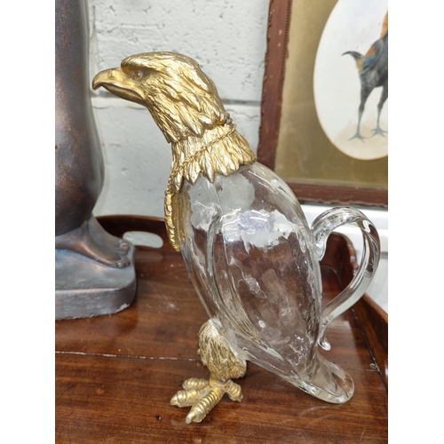 130 - A Crystal Decanter with a brass eagle surmount and claw feet. H 25 cm approx.