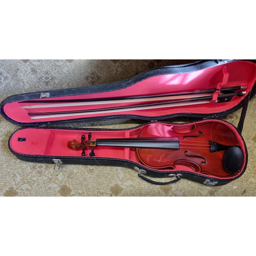 37 - A half size Violin with two bows and carry case.
L 54 cm approx.
