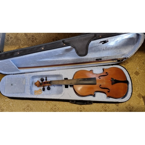 39 - A Violin and Bow in a carry case. L 59 cm approx.