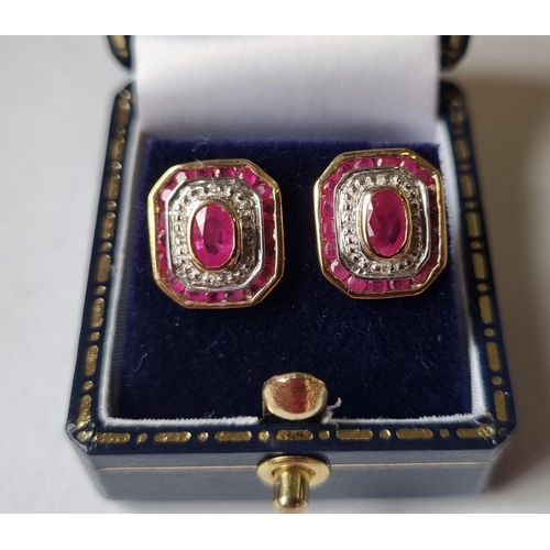 22 - A pair of Diamond and Ruby cluster Earrings.