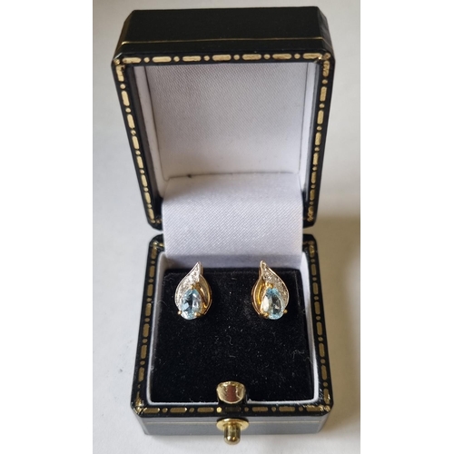 30 - A pair of Diamond and Topaz Earrings.
