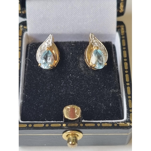 30 - A pair of Diamond and Topaz Earrings.