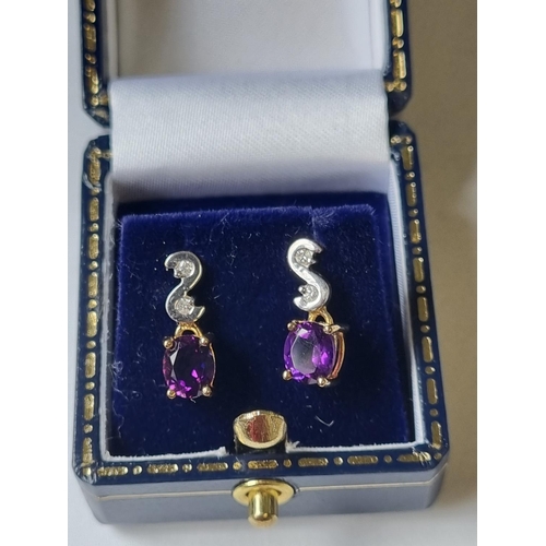 46 - A pair of Diamond and Amethyst Earrings.