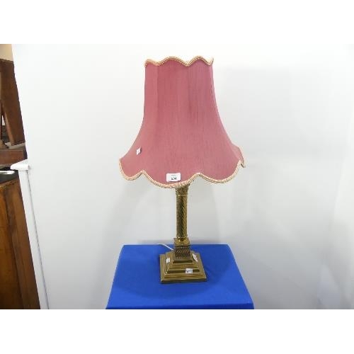 504 - A brass telescopic standard Lamp, in the form of a Corinthian column on a square base raised on claw... 