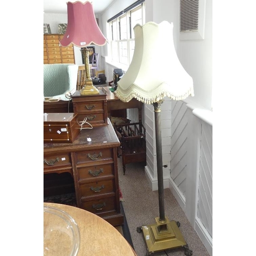 504 - A brass telescopic standard Lamp, in the form of a Corinthian column on a square base raised on claw... 