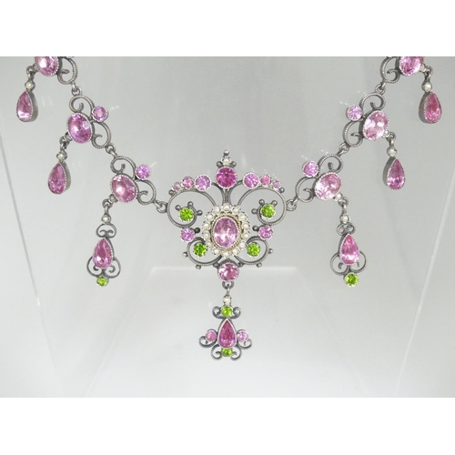178 - A Palais Royale style paste Necklace, set with eight open scroll links each set two pink pastes and ... 