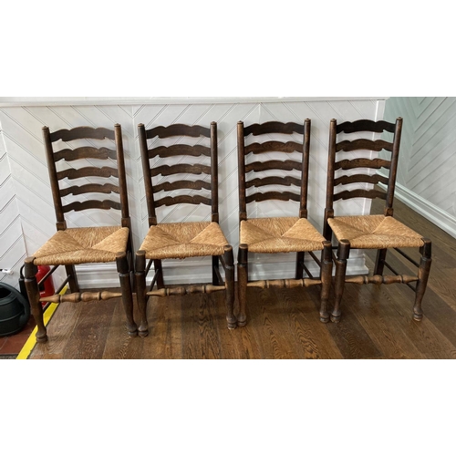 564 - A set of four early 20thC oak Ladder-back Chairs, the laddered back over the envelope rush seats, ra... 