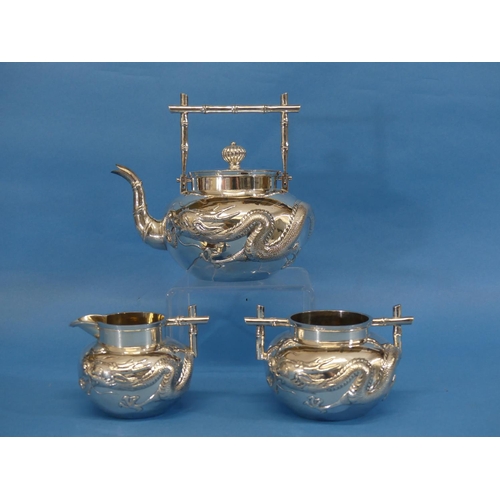 88 - A Chinese export silver three piece Tea Set, by Wang Hing, Canton, of circular form with 'bamboo' st... 
