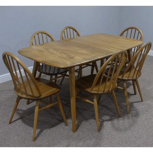 4 - A mid 20thC Ercol light elm plank top extending Dining Table, of rounded rectangular form, with spla... 