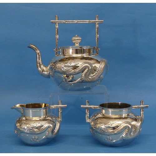 88 - A Chinese export silver three piece Tea Set, by Wang Hing, Canton, of circular form with 'bamboo' st... 