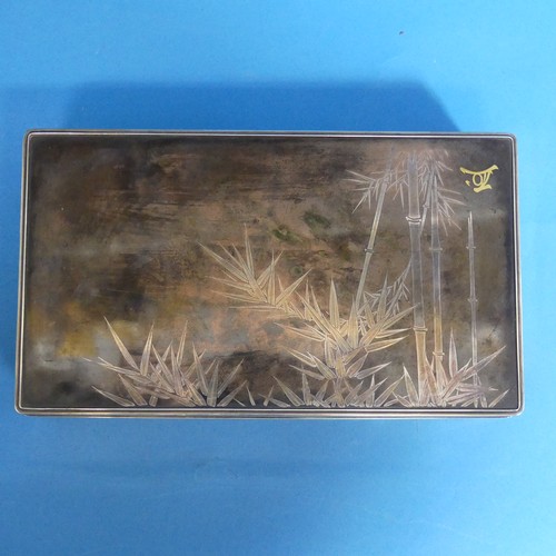 43 - A Japanese Meiji Period silver Cigarette Box, of rectangular form, the plain body with lift off lid ... 
