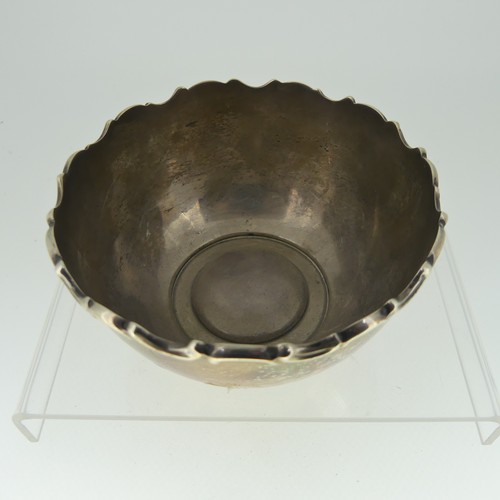 44 - A small Edwardian circular silver Bowl, hallmarked Chester, 1906, with moulded scrolling rim, 10cm d... 