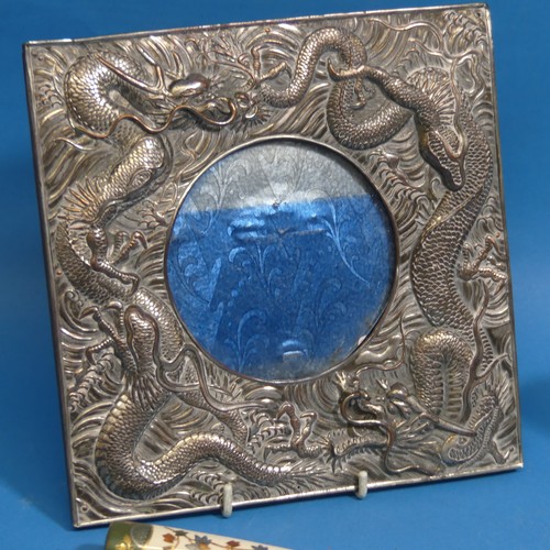 60 - A 20thC Japanese silver plated Photo Frame, with circular glazed aperture surrounded by dragons in r... 