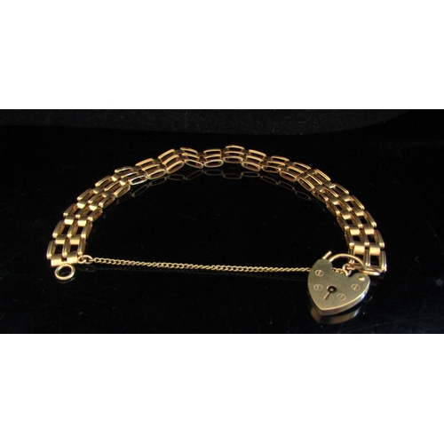 5018 - A 9ct gold gate charm bracelet with heart lock, 11g