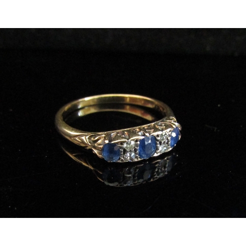 5021 - An 18ct gold sapphire and diamond dress ring. Size V, 4.1g