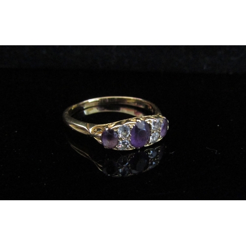 5022 - An 18ct gold amethyst and diamond dress ring. Size V, 4.1g