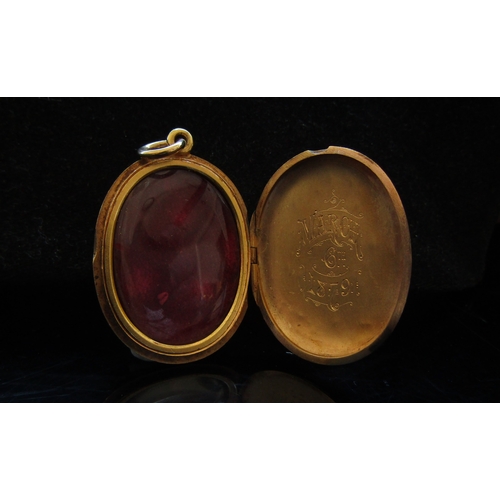5026 - A Victorian gold oval locket with monogram to front and inscribed to interior March 6th 1879, unmark... 