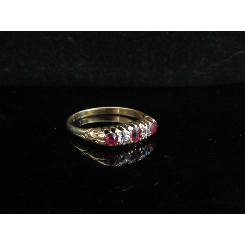 5029 - An 18ct gold five stone ruby and diamond ring. Size Q/P, 3g