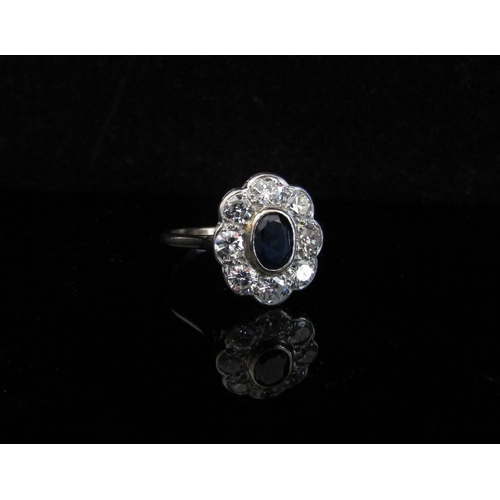 5031 - A white gold sapphire and diamond cluster ring, 0.80ct approx total diamonds, stamped 18ct, rubbed. ... 