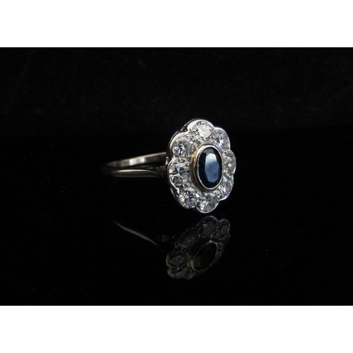 5031 - A white gold sapphire and diamond cluster ring, 0.80ct approx total diamonds, stamped 18ct, rubbed. ... 