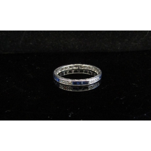 5032 - A diamond and sapphire eternity ring, unmarked white gold. Size Q, 2.7g