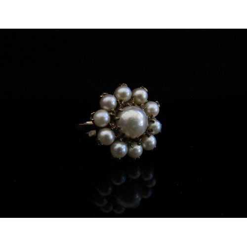 5033 - A 9ct gold pearl daisy ring. Size Q, 5.8g