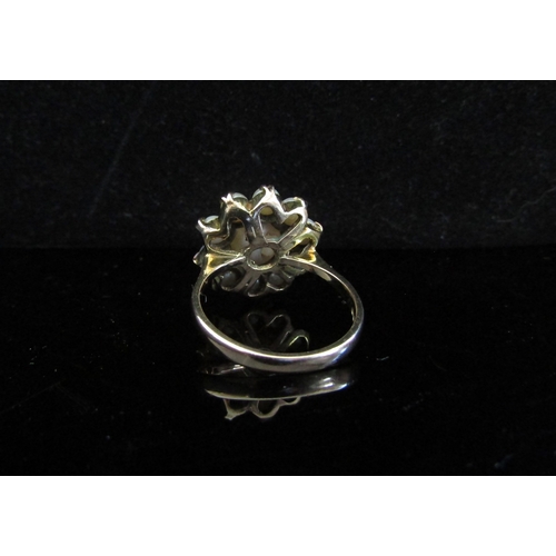 5033 - A 9ct gold pearl daisy ring. Size Q, 5.8g