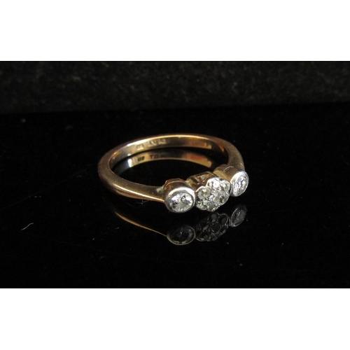 5043 - An 18ct gold platinum set three stone diamond ring in illusion setting. Size M, 2.8g    (R) £75