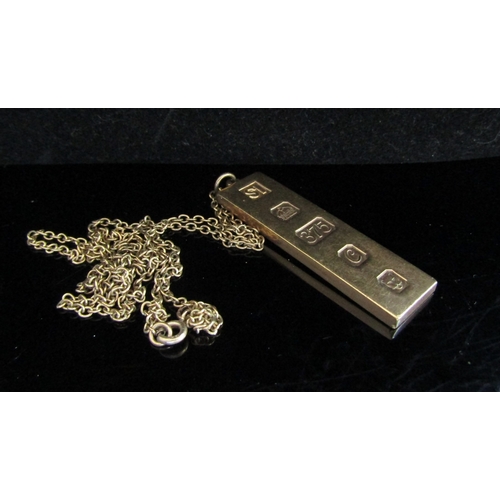 5046 - A 9ct gold ingot pendant hung on gold chain stamped 9k, 54cm long, 22.5g