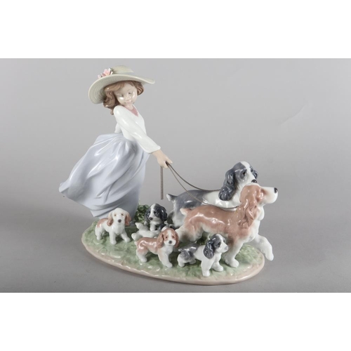 30 - A Lladro porcelain figure of a girl with dogs, 