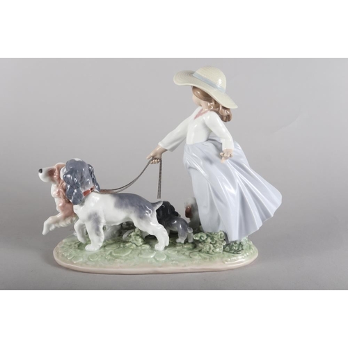 30 - A Lladro porcelain figure of a girl with dogs, 