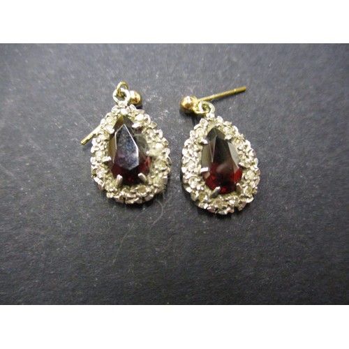 54 - A pair of diamond and garnet earrings