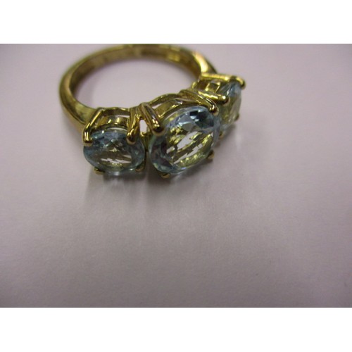7 - A 9ct gold ring set with 3 light blue stones. Approximate weight 3.4g, approximate ring size K