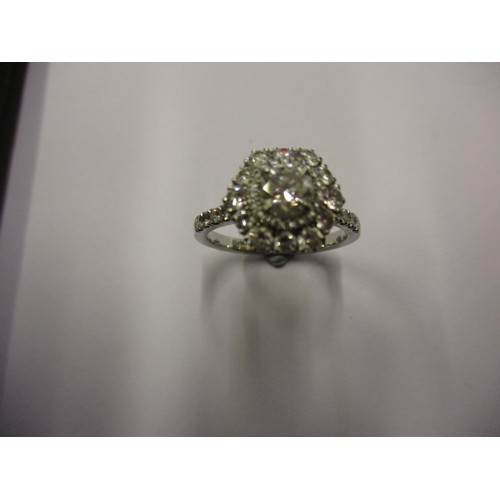 17 - A 950 platinum ‘Halo’ Ring, the central diamond being approx. 0.6ct approx. ring size M,
