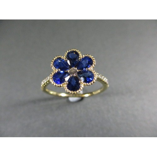 60 - An 18ct yellow gold sapphire and diamond flower style dress ring, approximate ring size P. Sapphire ... 