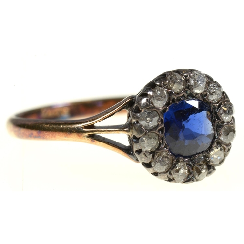 1 - A SAPPHIRE AND DIAMOND RING  the cushion shaped sapphire surrounded by old cut diamonds, gold hoop m... 