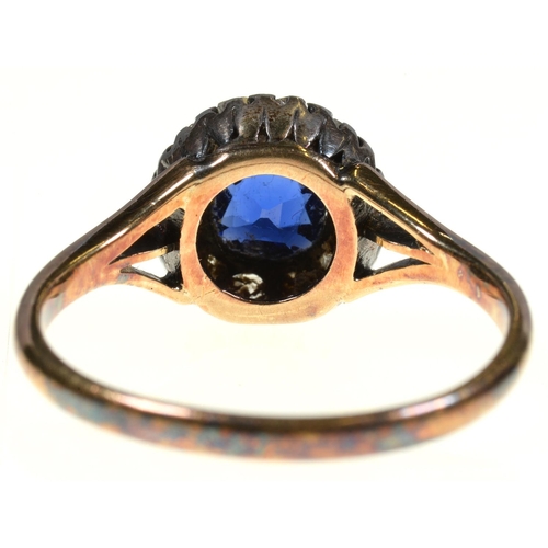 1 - A SAPPHIRE AND DIAMOND RING  the cushion shaped sapphire surrounded by old cut diamonds, gold hoop m... 