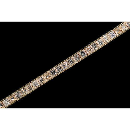13 - A DIAMOND LINE BRACELET with princess cut diamonds of approx 10ct in total, in gold, 179mm l, marked... 