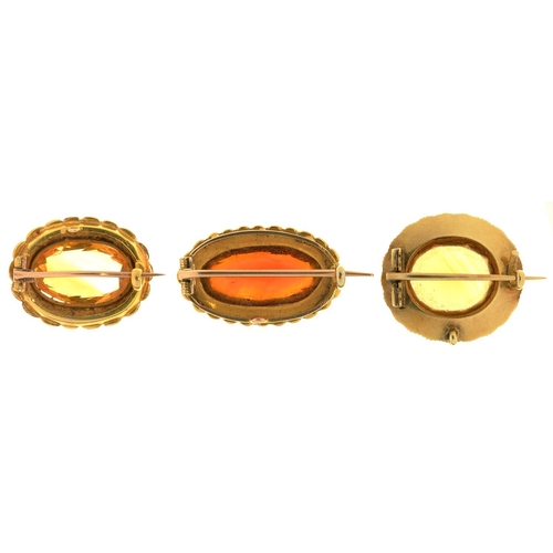 44 - THREE VICTORIAN CITRINE AND PEARL BROOCHES, MID 19TH C  in gold, 256mm and smaller, 14g... 