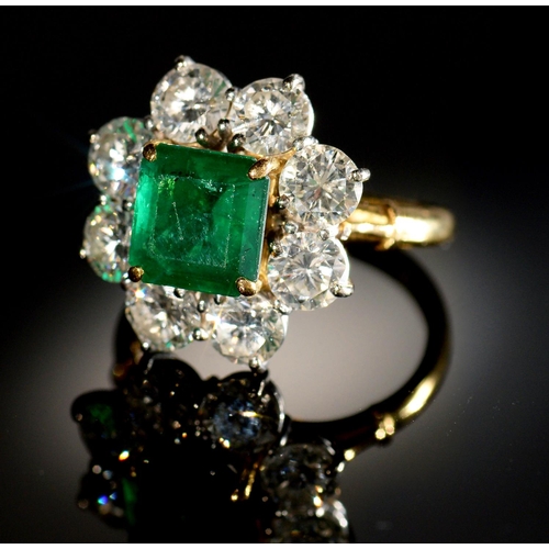 7 - AN EMERALD AND DIAMOND RING,  with step cut emerald of approx 6 x 6mm and of approx 2ct, in a surrou... 