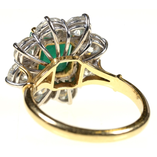 7 - AN EMERALD AND DIAMOND RING,  with step cut emerald of approx 6 x 6mm and of approx 2ct, in a surrou... 