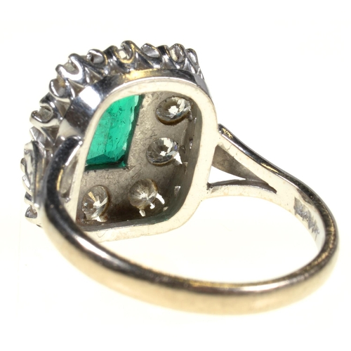 8 - AN EMERALD AND DIAMOND RING  the step cut emerald of approx 4 x 6mm in a surround of ten evenly size... 