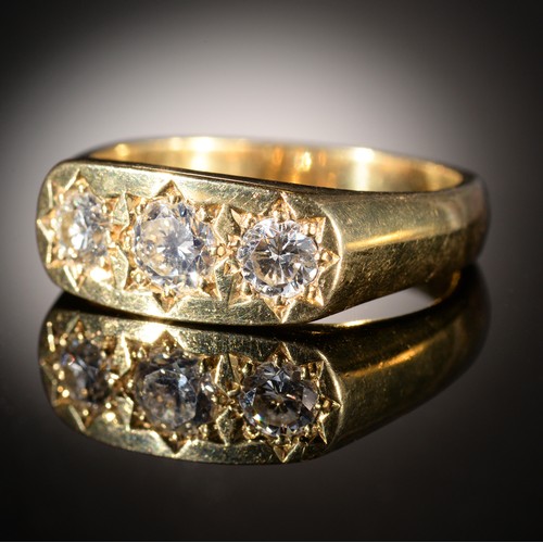 40 - A DIAMOND RING gipsy set with three modified round brilliant cut diamonds, in 18ct gold, London 1979... 