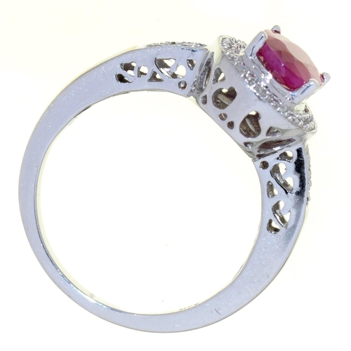 34 - A RUBY AND DIAMOND CLUSTER RING, IN WHITE GOLD WITH PIERCED SHOULDERS, MARKED 14K, 4.1G, SIZE M