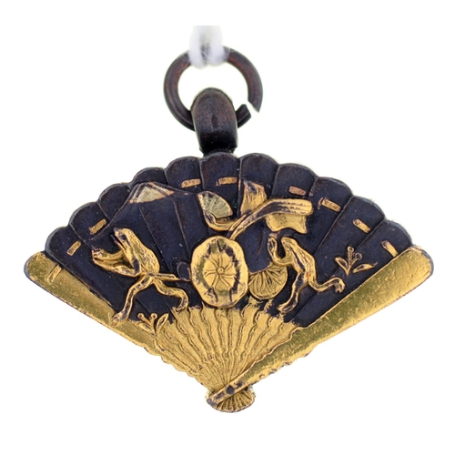 60 - A JAPANESE SHIBUICHI AND GOLD FAN SHAPED FOB PENDANT, THE BACK INSET WITH A COMPASS, MEIJI PERIOD, 2... 