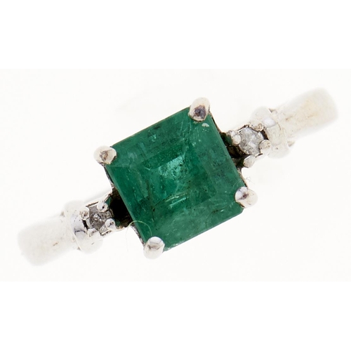 5 - An emerald and diamond ring, with larger central step cut emerald, in 9ct white gold, 2.2g, size G