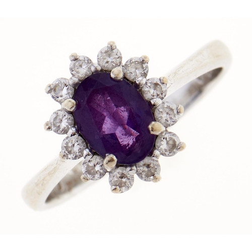 6 - An amethyst and white stone cluster ring, in white gold, marked 14K, 3.1g, size K